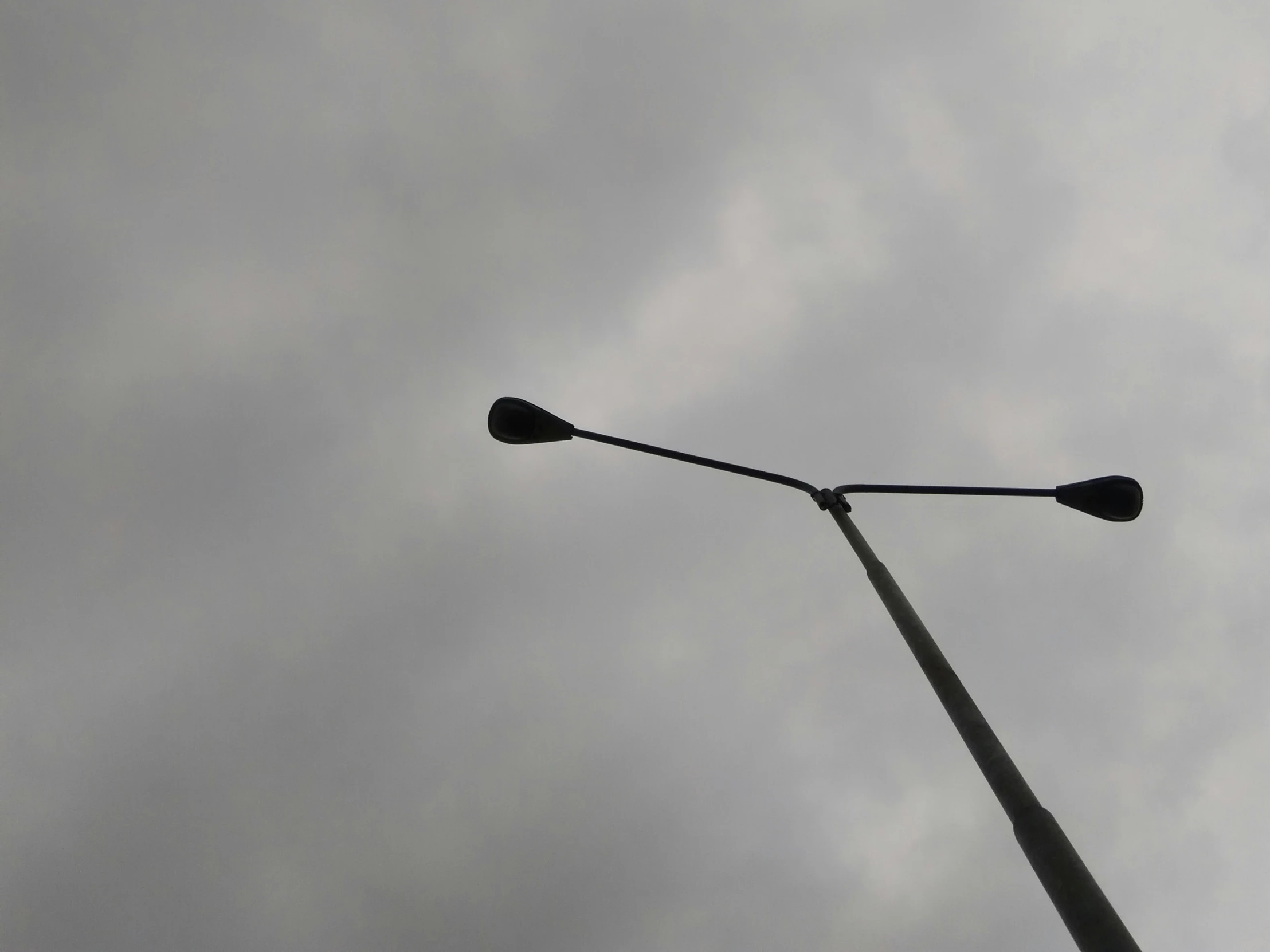 traffic lights on the street under a cloudy sky