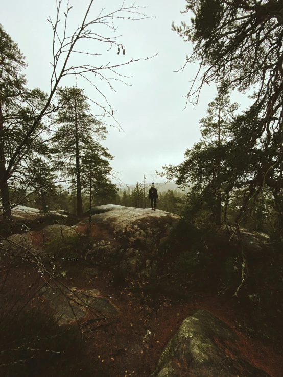 a man standing on top of a dirt hill