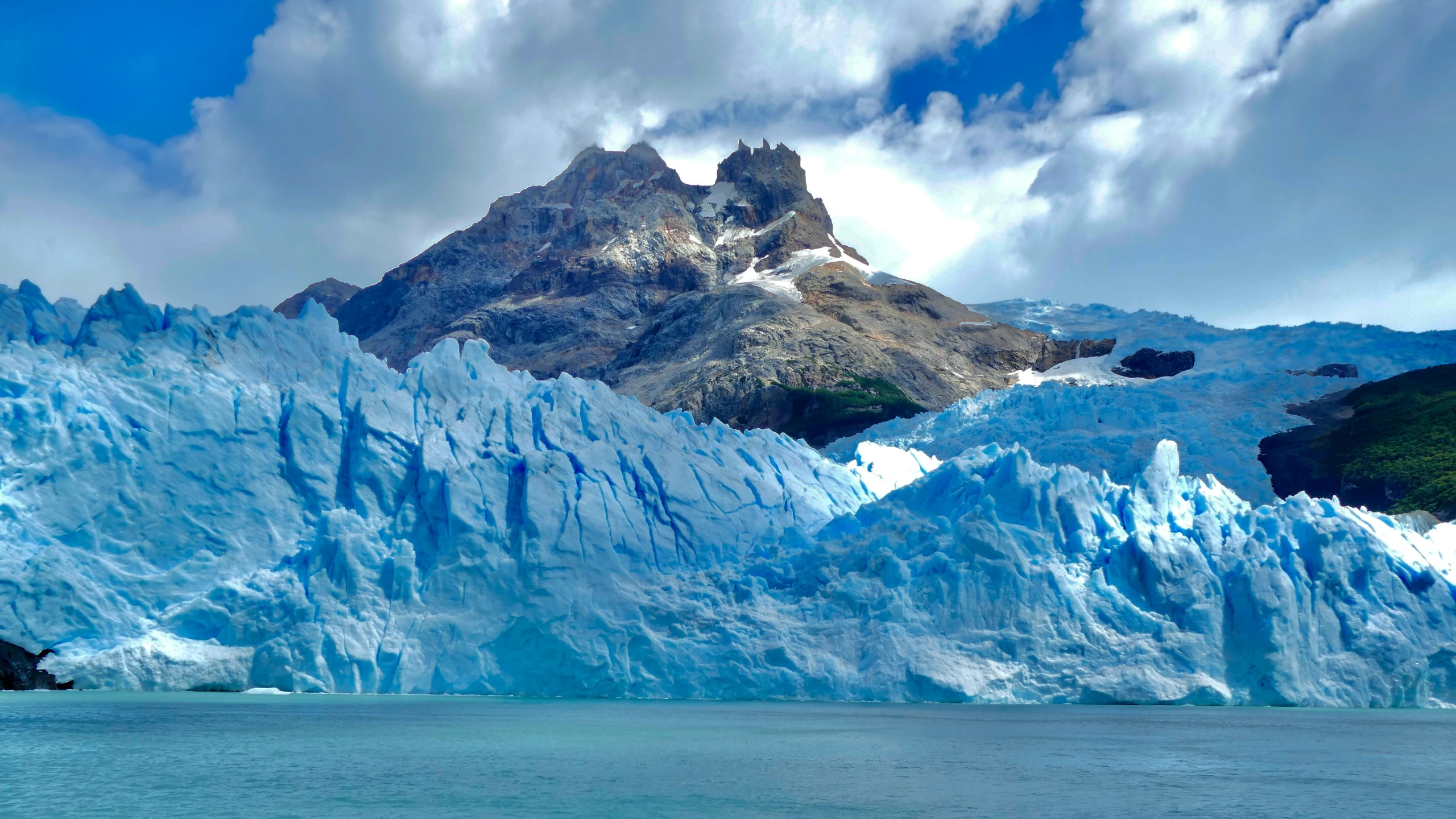 an image of ice melting and mountains in the background