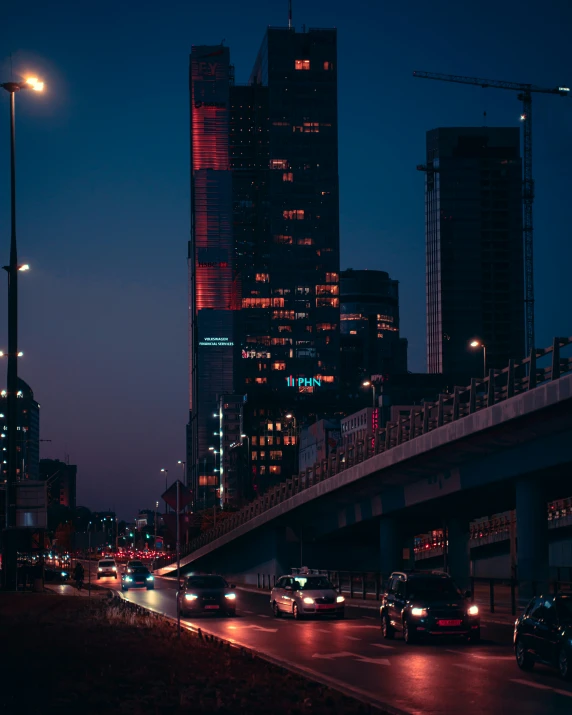 a city street at night with traffic and street lights