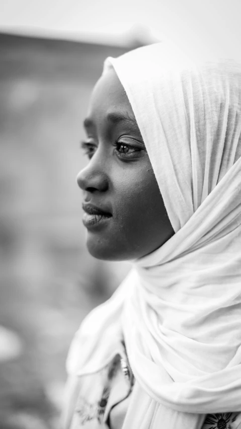 a woman with a white headscarf and long hair