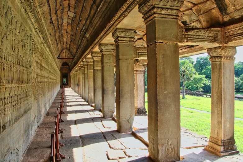 a long row of pillars sitting in the middle of an outdoor area