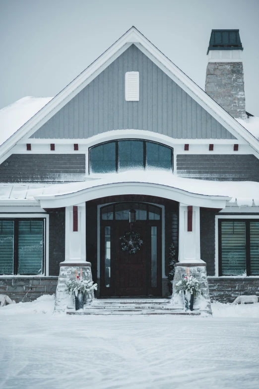 the front entrance to a home on a snow covered day