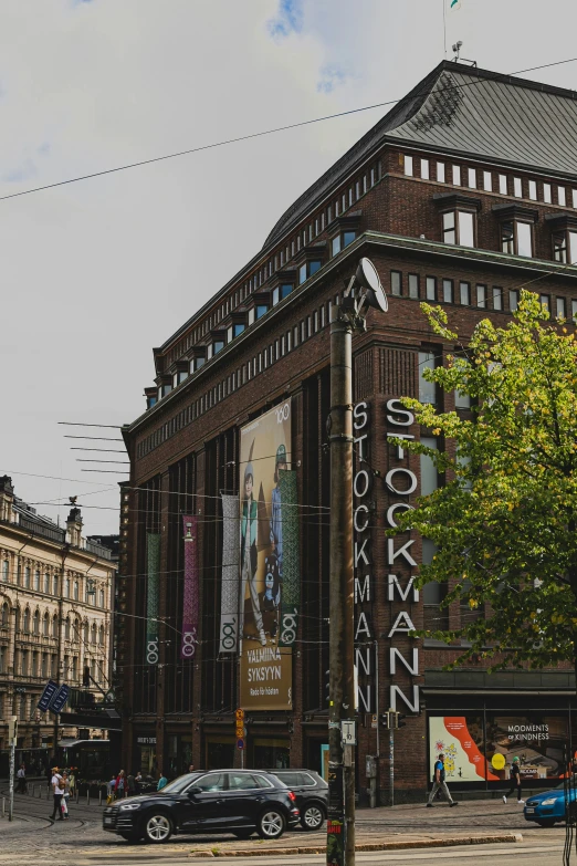 a building is next to cars and people in the street