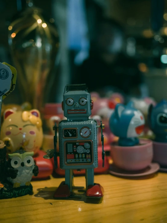 little robots are posed by a cup on the table