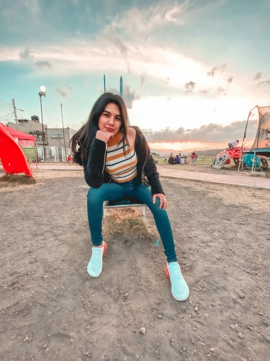 a girl sitting on a bench at the beach