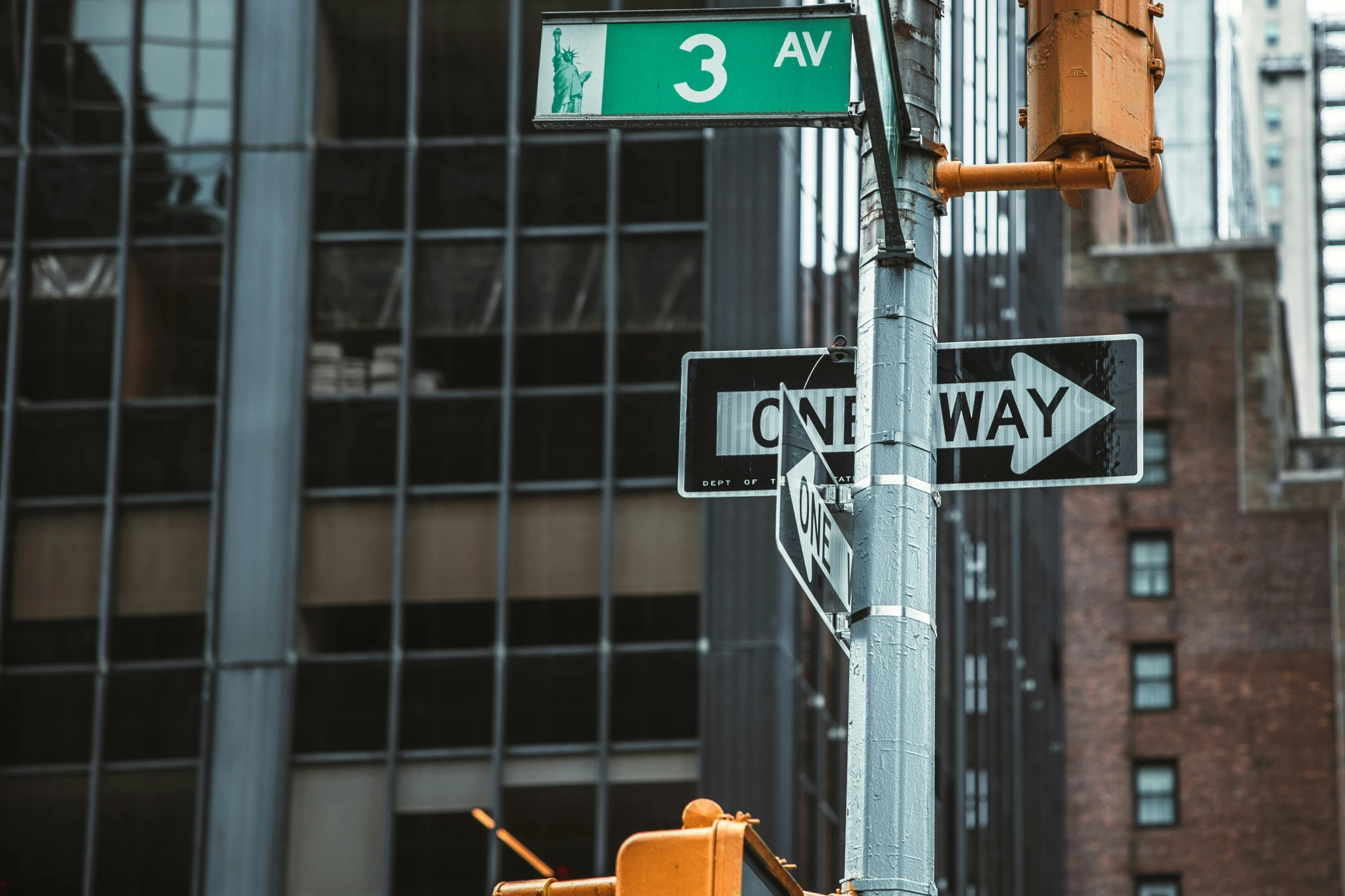 a traffic light with a couple signs hanging from the side