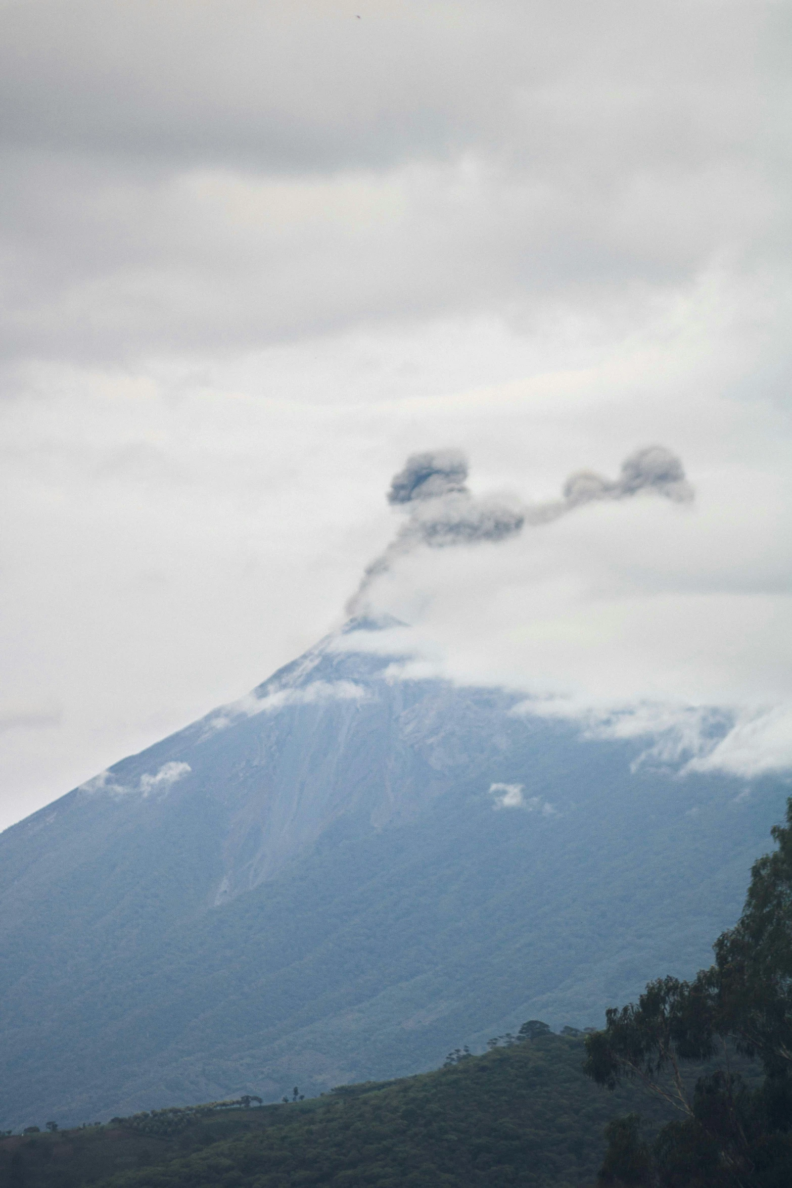 a mountain top with a plume of steam coming out of the bottom