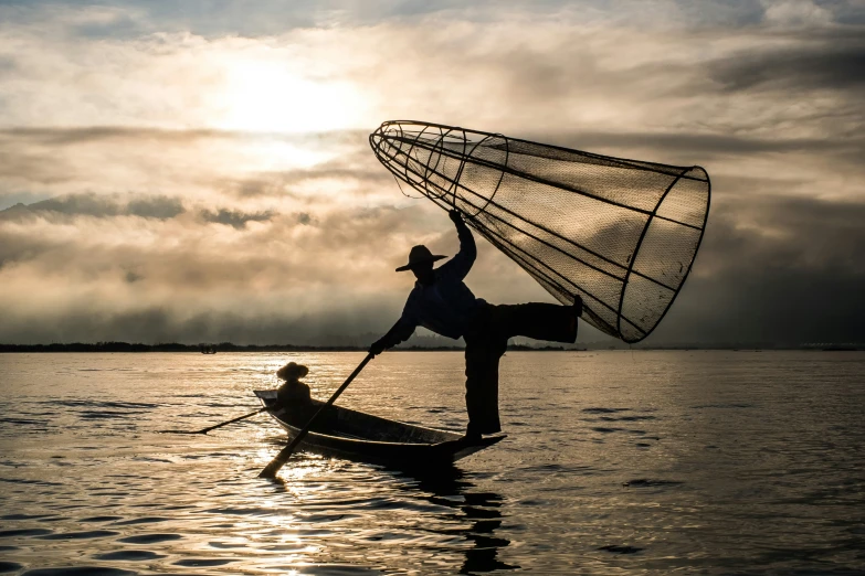 a man riding on the back of a sail in a small boat