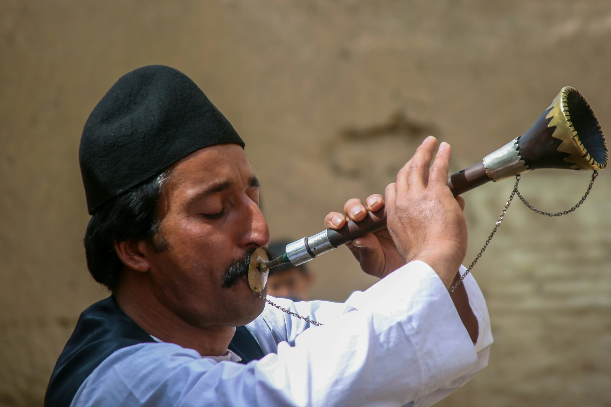 a man is playing a musical instrument on the street