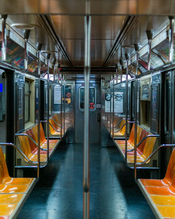 seats and railings on the inside of a public transportation train