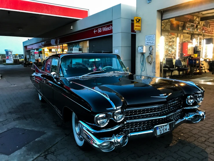 an antique car sits on the side of the street