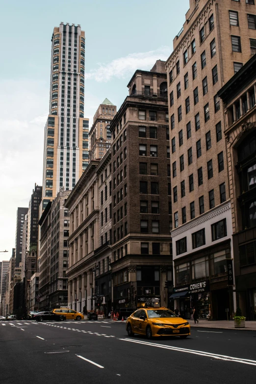 an empty street with cabs and high rise buildings