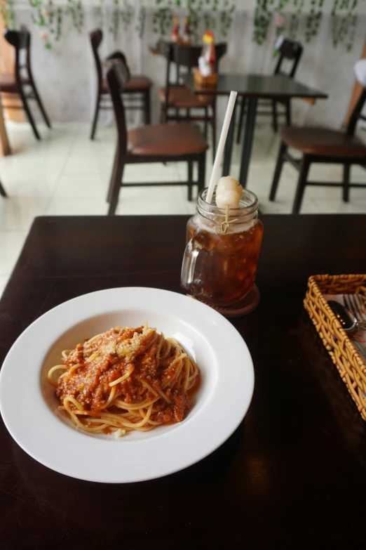 a plate of pasta and soup is sitting on the table