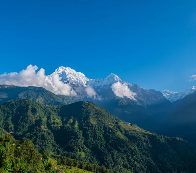 the clouds are flying above the mountains