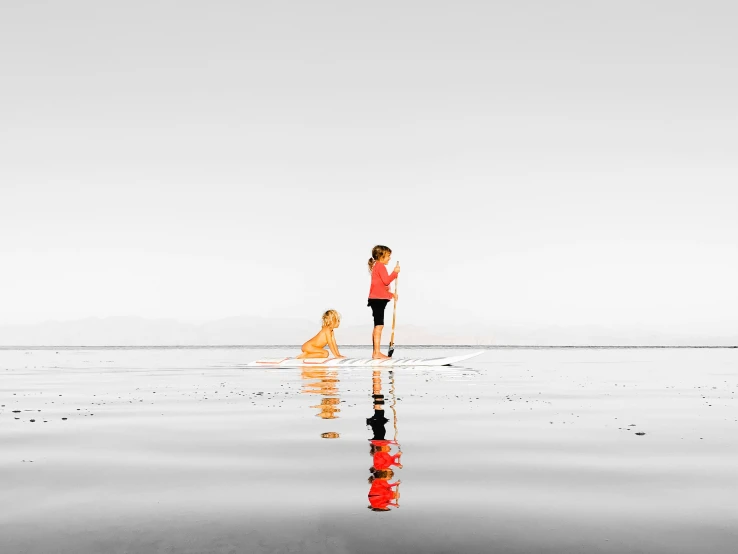 the woman and dog are walking on the beach