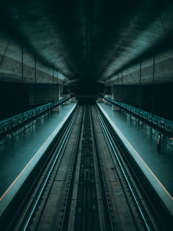 a long s of some train tracks in a tunnel