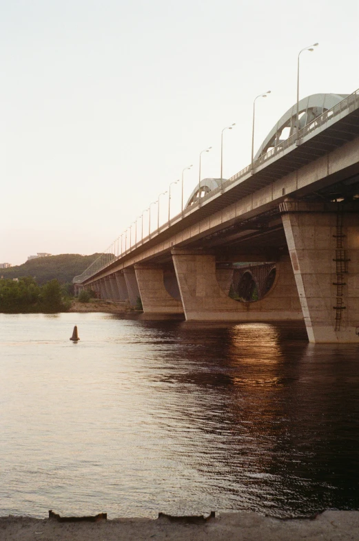 a train bridge over a river under a sky