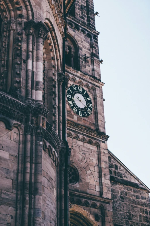 an old stone building with a clock on the front