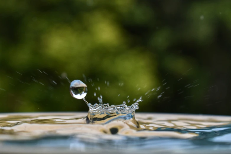 a water drop being thrown on to a bowl