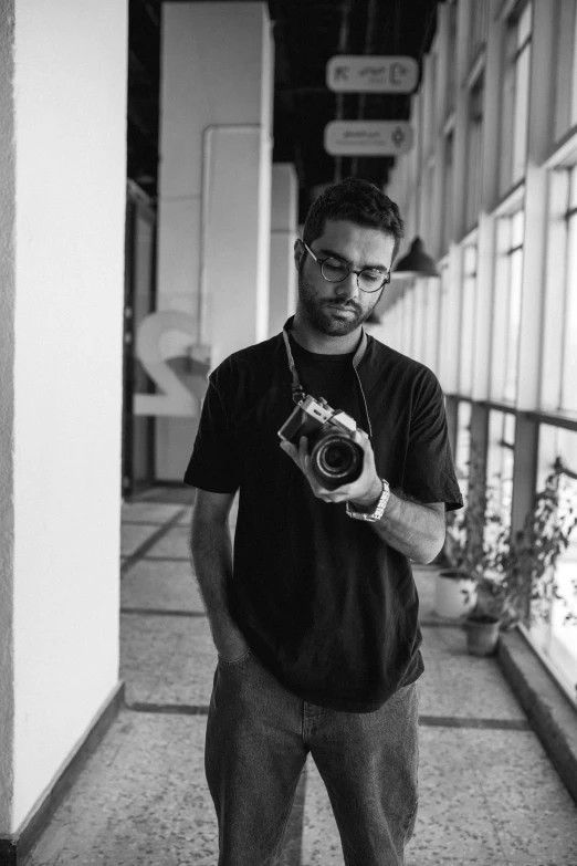 a man standing outside with a camera in his hands