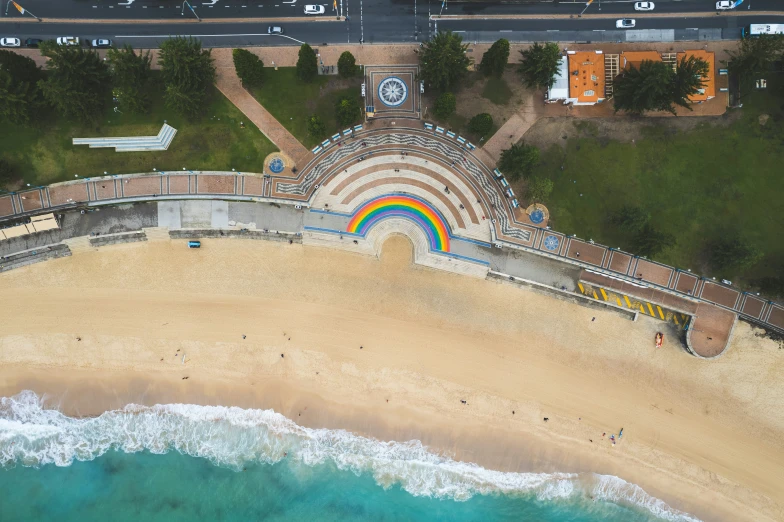 a colorful rainbow painted building next to the ocean