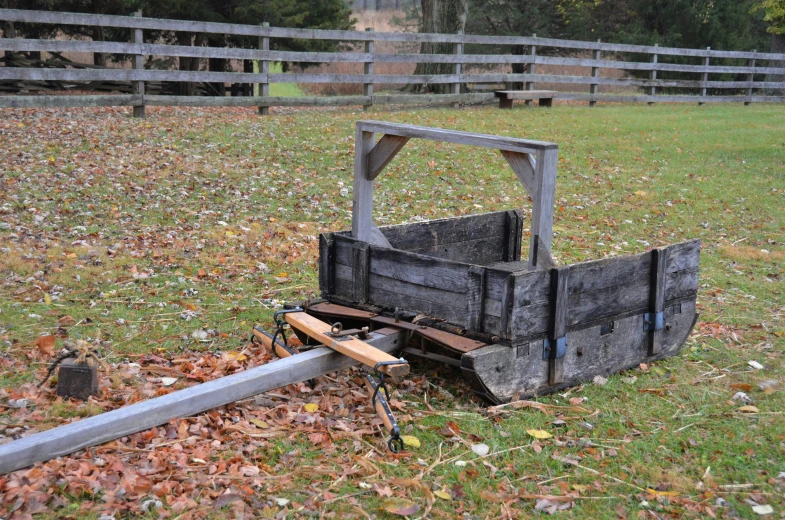 an old metal crate sitting in the grass