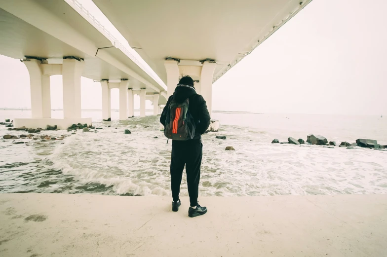 a person stands in front of an underpass