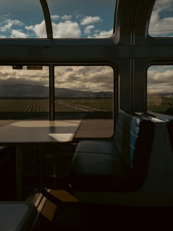 the interior of an empty train car with many tables