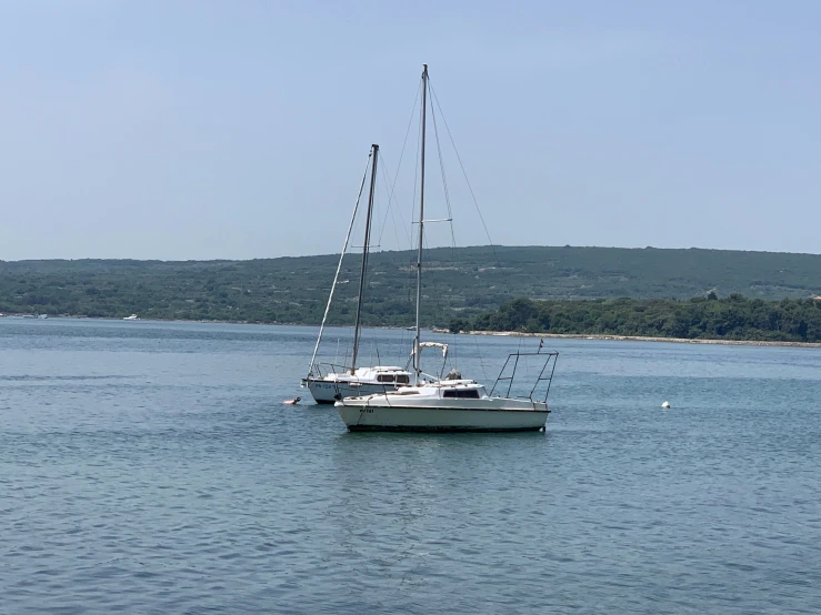 two boats floating side by side in the water