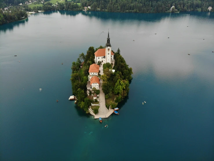 a large island with houses sits in the middle of a body of water