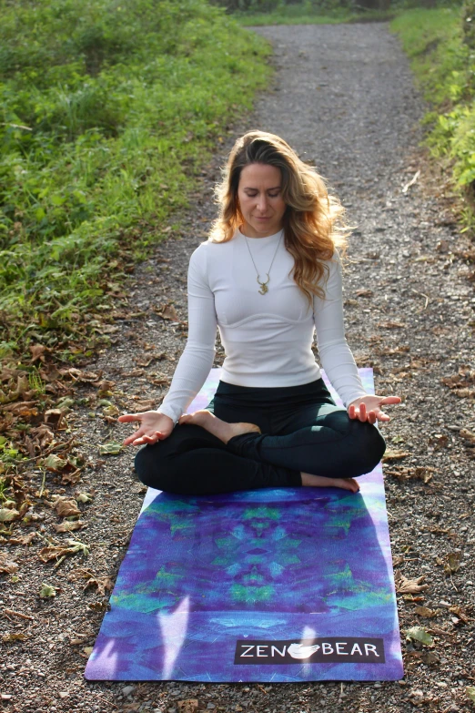 a woman practicing yoga on a trail path