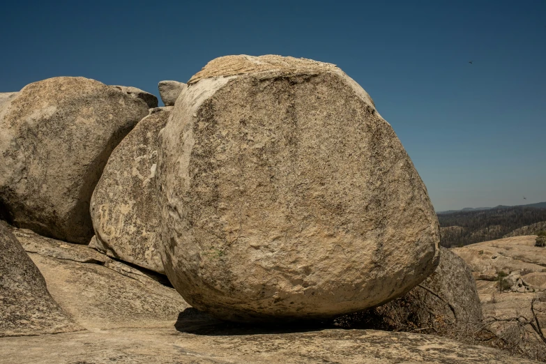 some big rocks that are in the grass