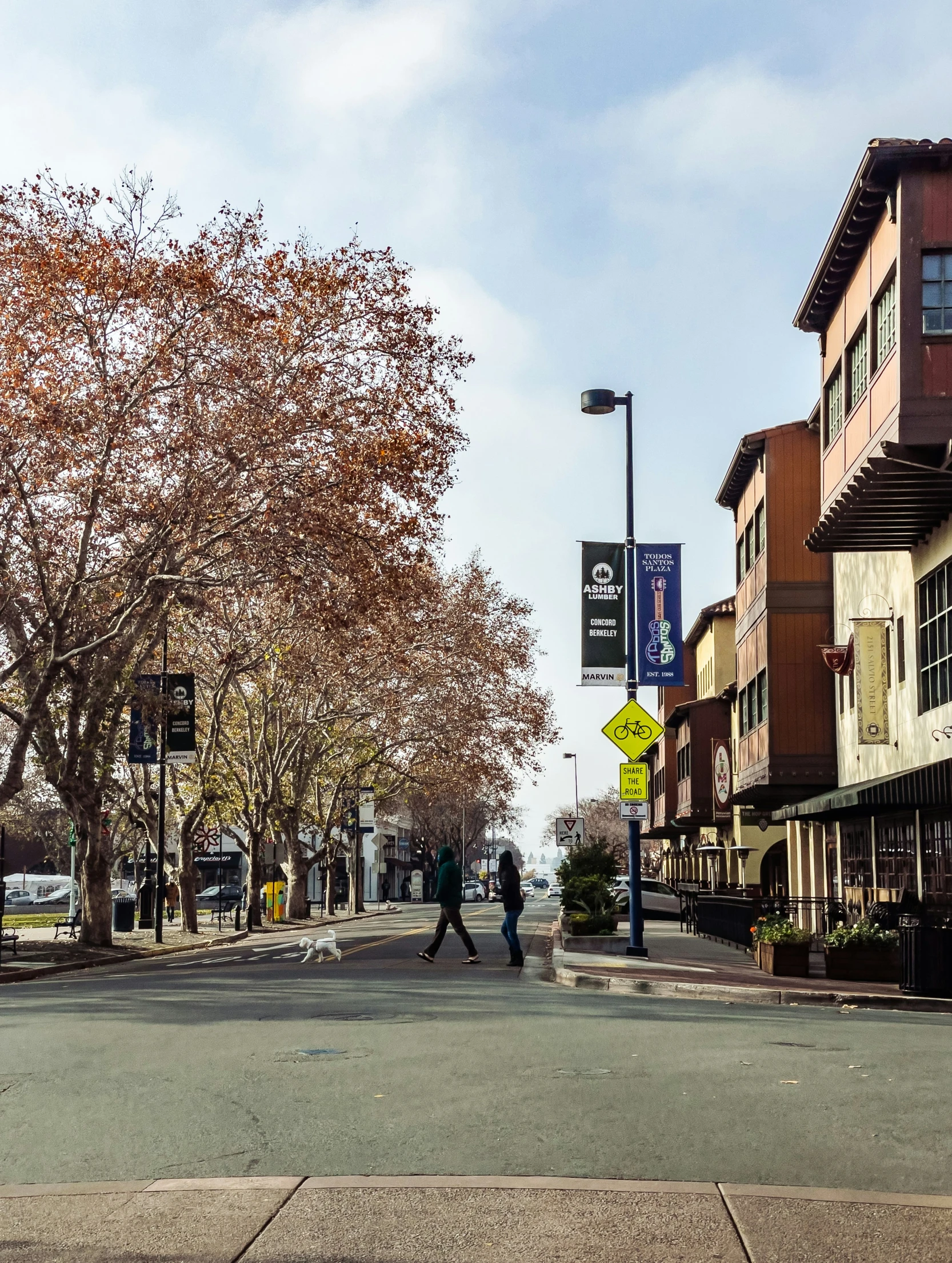 the two people are walking down the street