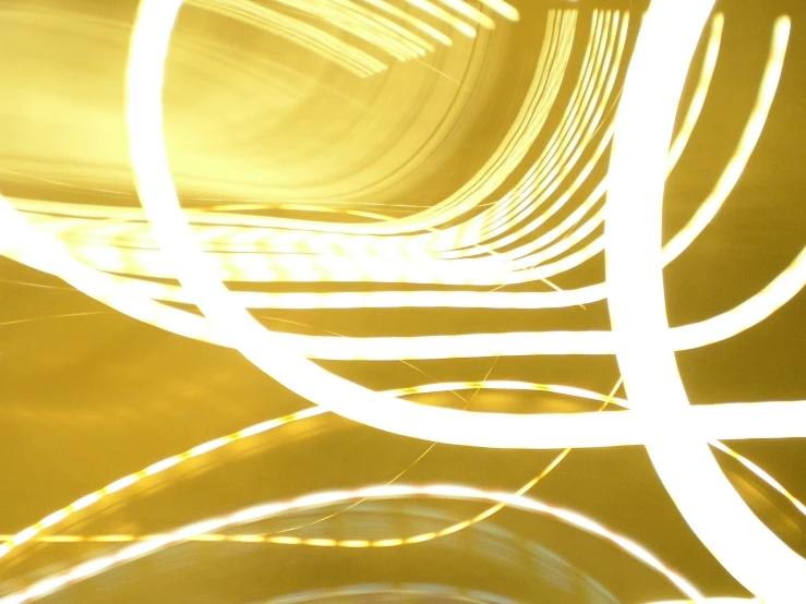 a yellow colored abstract image of several curved lines