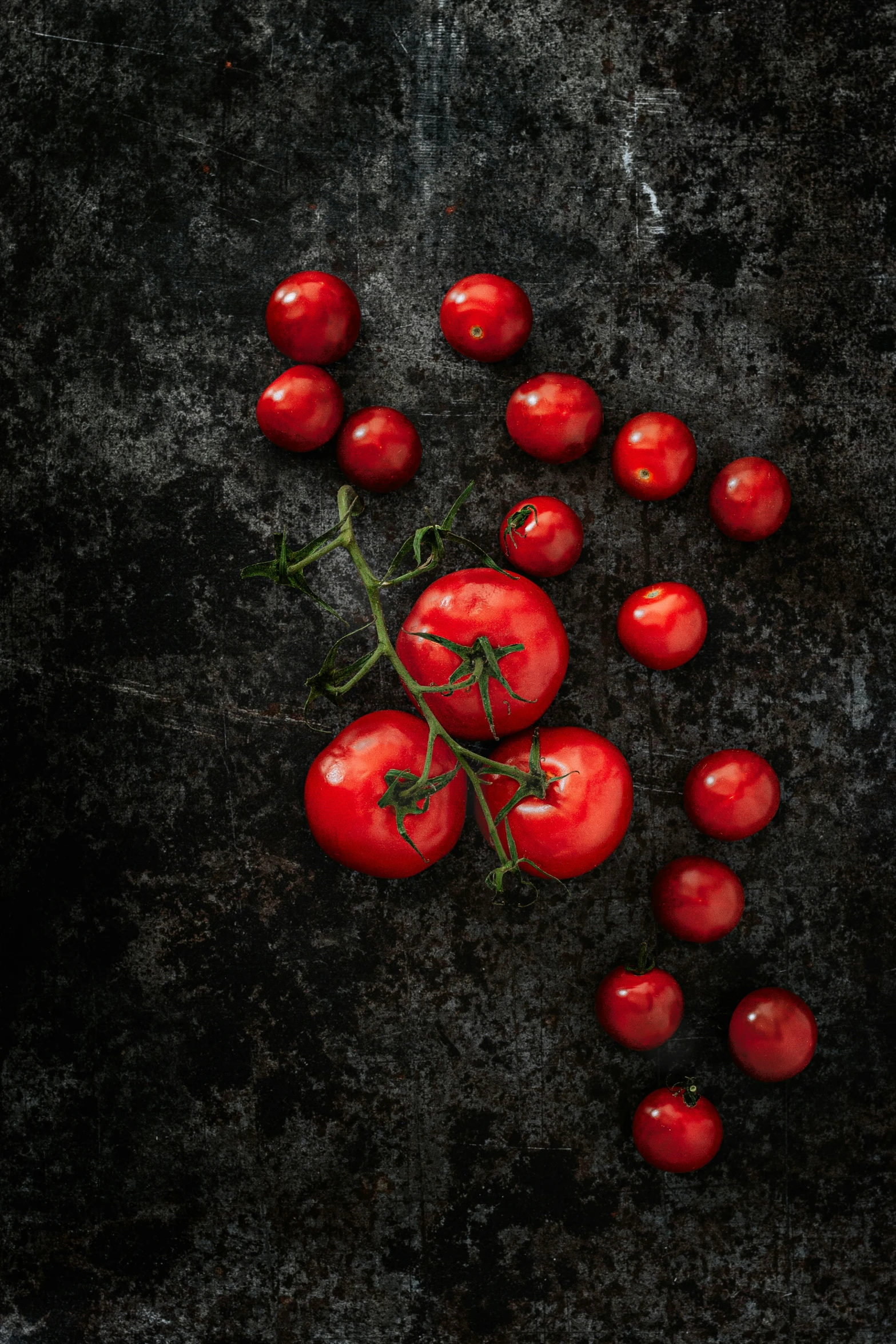 five tomatoes are arranged on a table top