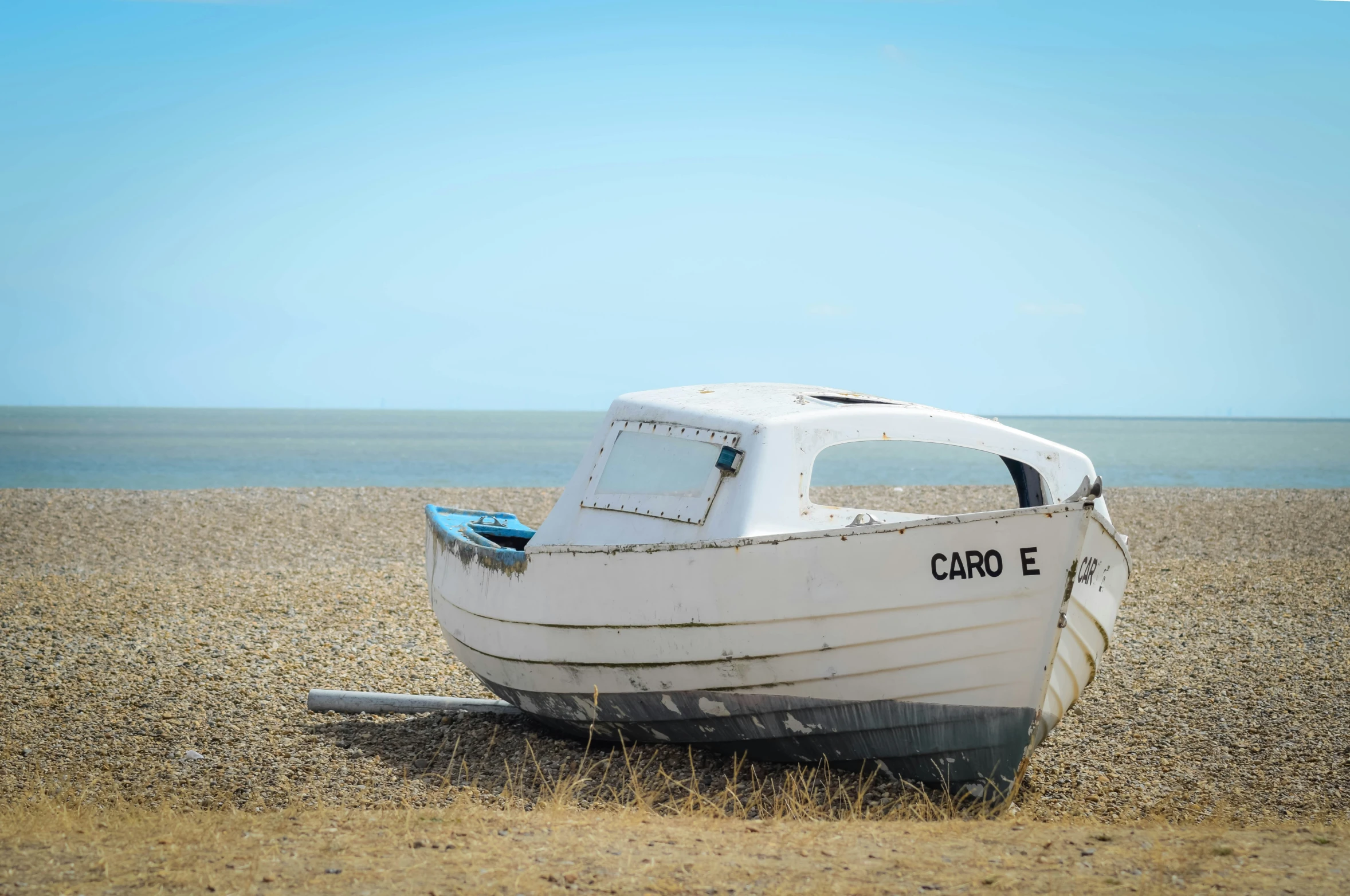 a small boat is laying on the beach