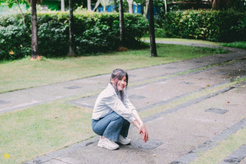 there is a woman sitting on steps in the grass