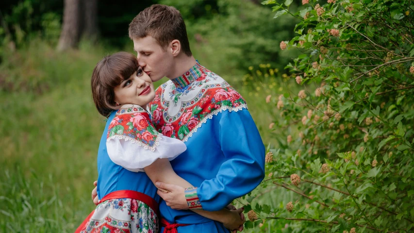 a man and a woman are hugging in a field