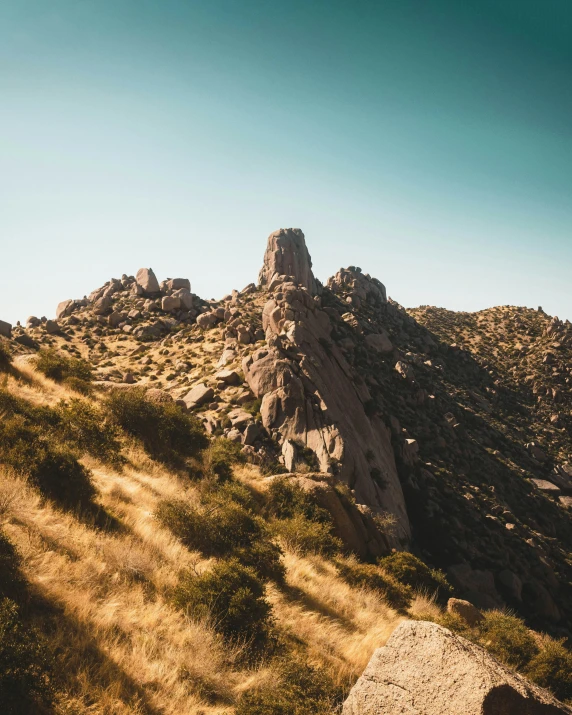 a large rocky mountain with some vegetation growing out of the top