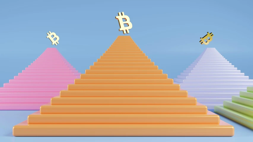 the pyramid of colored plates with bitcoin cutouts are in front of a blue sky