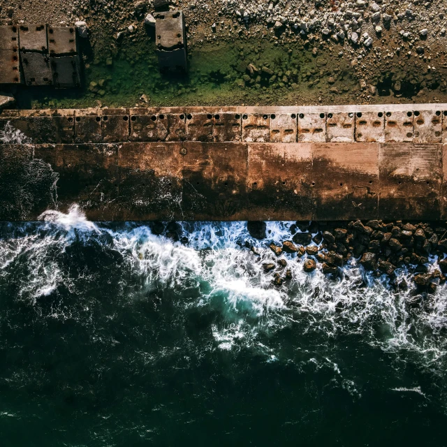 an aerial view of waves crashing into the shore