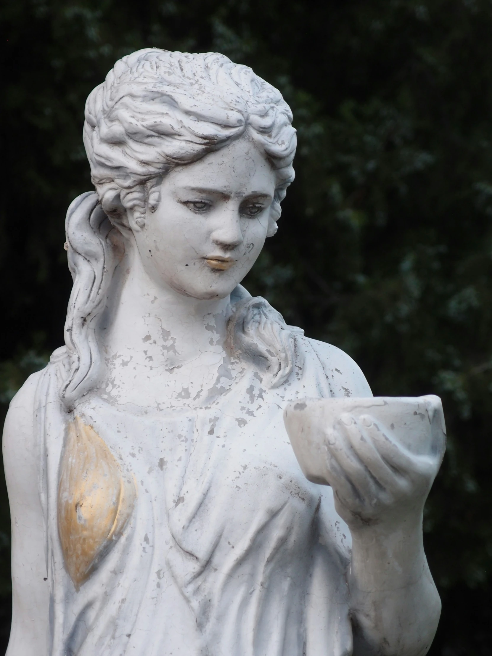 an image of statue with bird in her hand