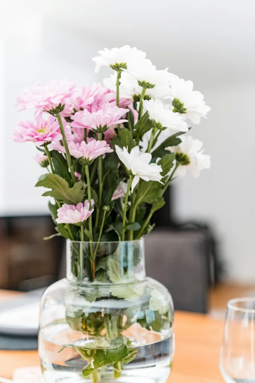 small floral arrangement in small glass vase with water