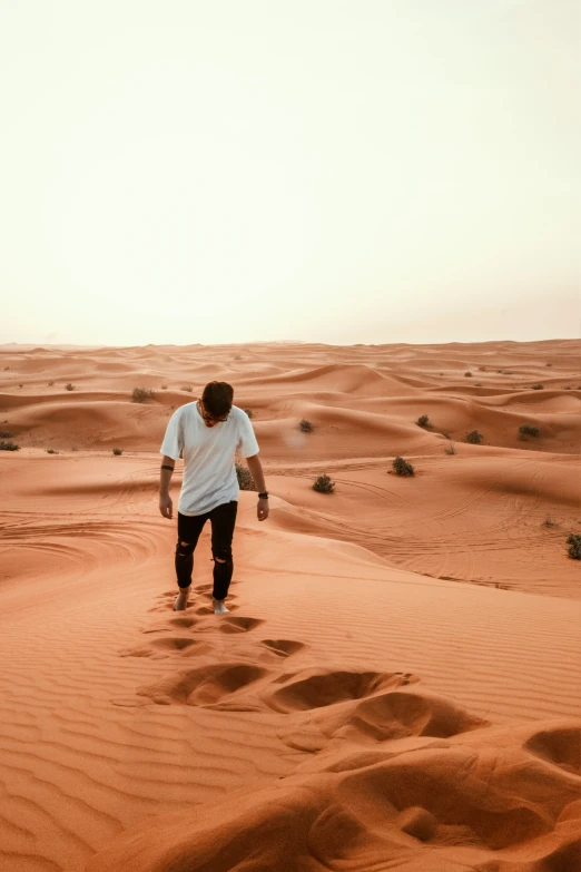 man walking in the desert toward the camera