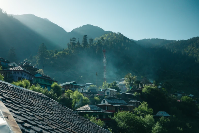 a residential village nestled on a hill near a forest