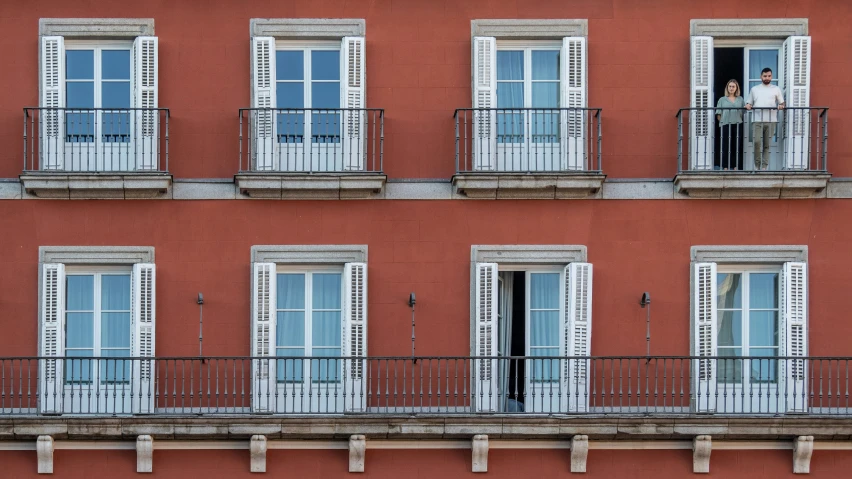 a man is standing outside a closed window