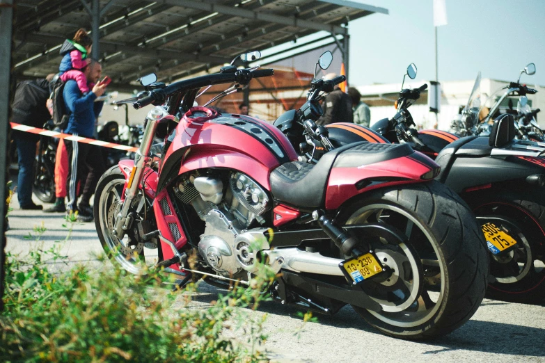 many motorcycles parked close together on the concrete