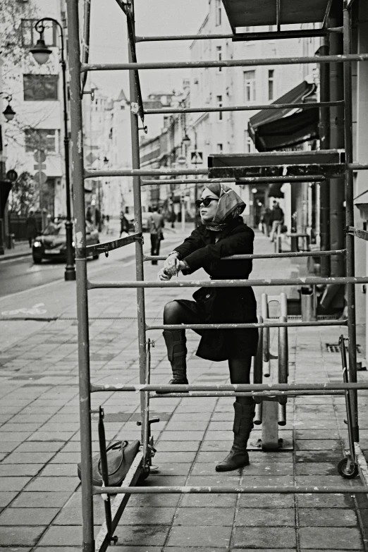 black and white pograph of an older woman on a bus stop