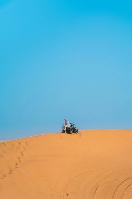 a man riding on a motorcycle in the sand
